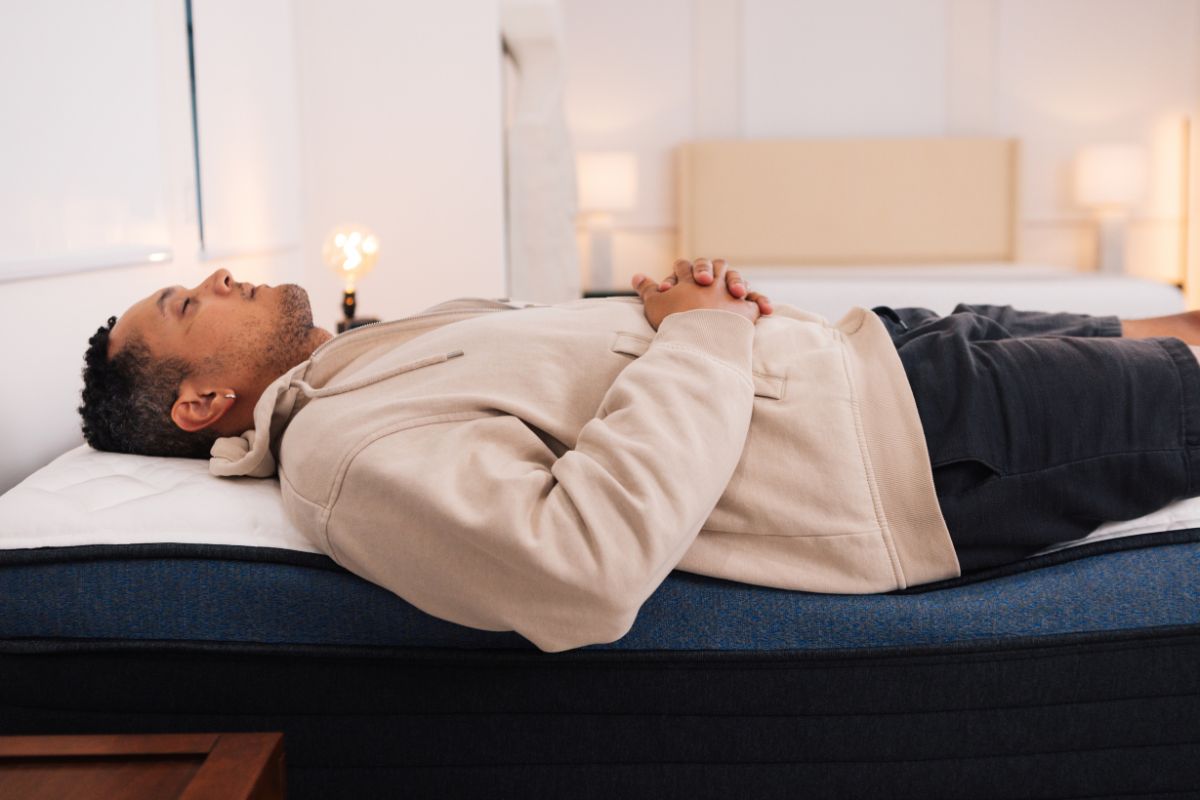 A man resting on a mattress.