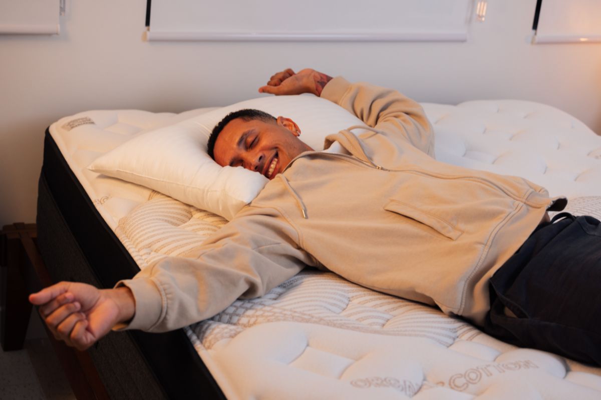 A man wearing comfortable clothes lying down on a bed.