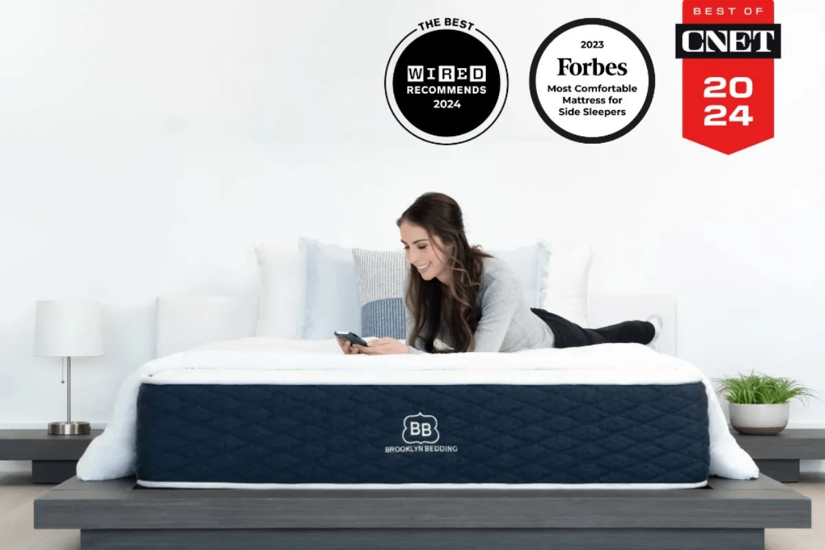 Person lying on Brooklyn Bedding Signature Hybrid mattress with certifications and awards highlighting safety and material standards