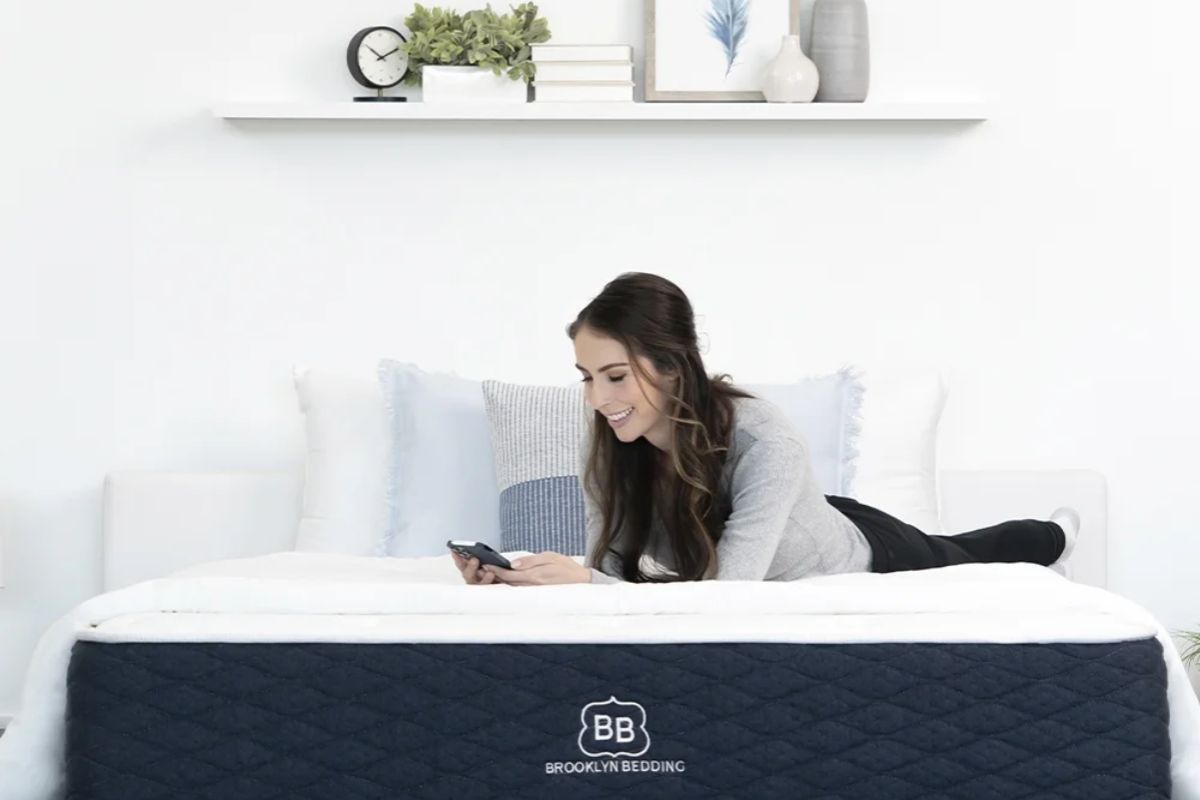 Person using Brooklyn Bedding Signature Hybrid mattress at home illustrating real use before return process
