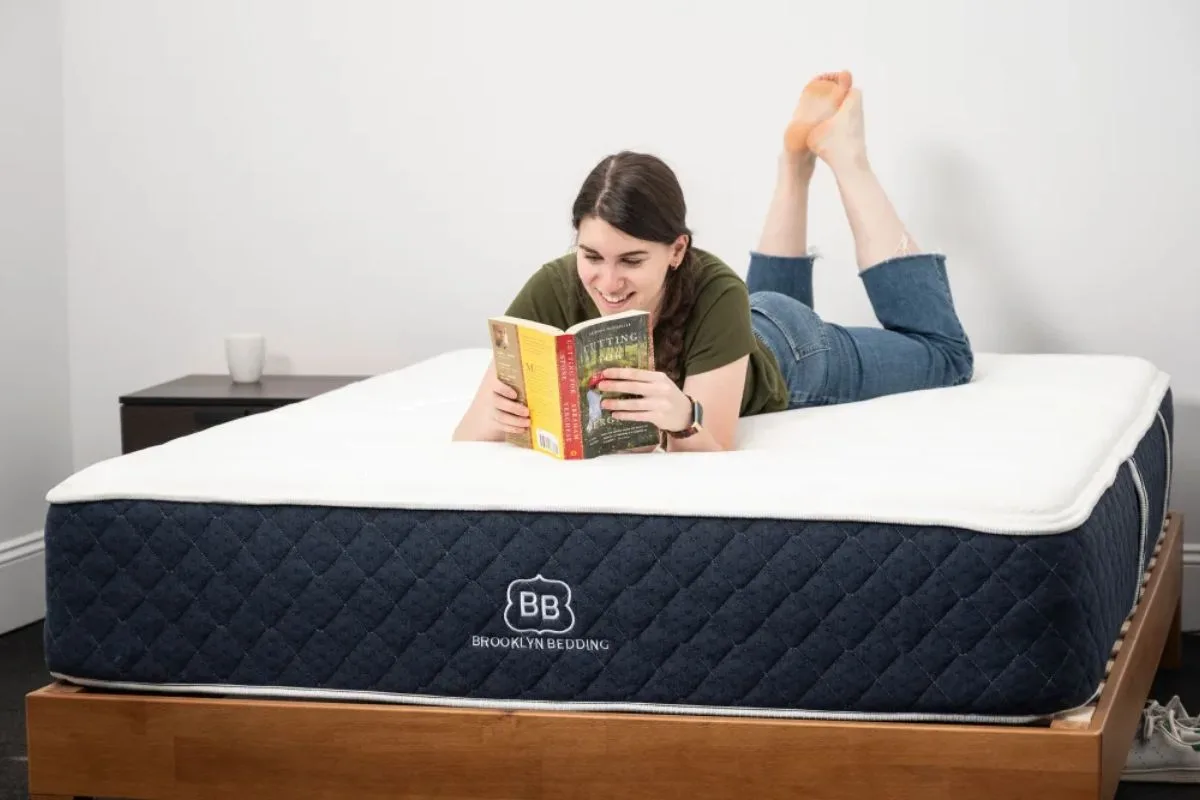 Person lying on Brooklyn Bedding Signature Hybrid mattress testing comfort at home during trial period
