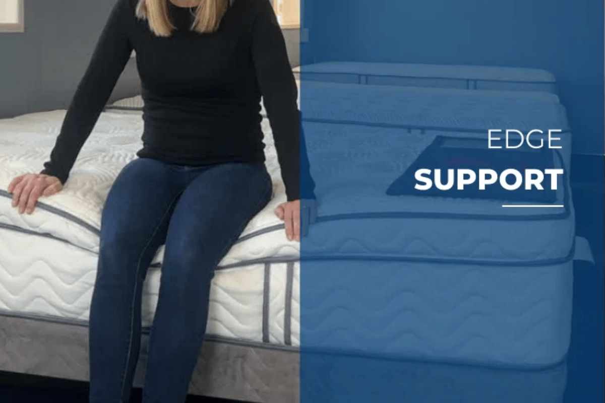 Person sitting on DLX Premier Hybrid mattress edge demonstrating stability and structural safety