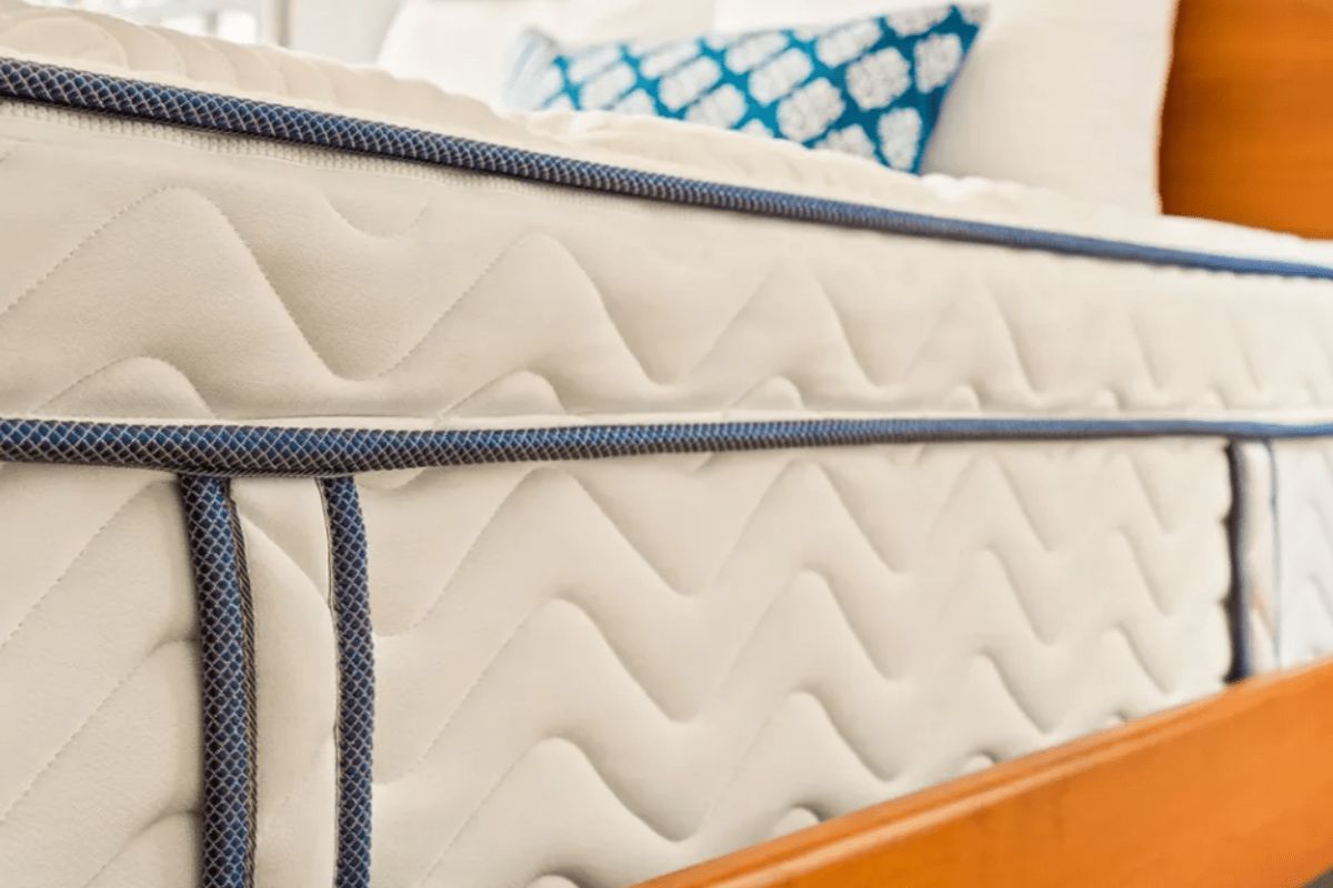 Close-up of DLX Premier Hybrid mattress handles and stitching for moving during return