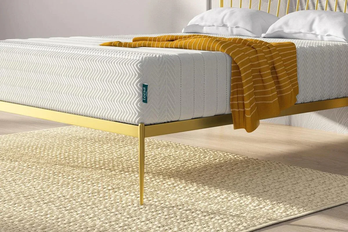 Leesa Legend Hybrid mattress close-up on gold frame with textured cover and throw blanket in bedroom setting