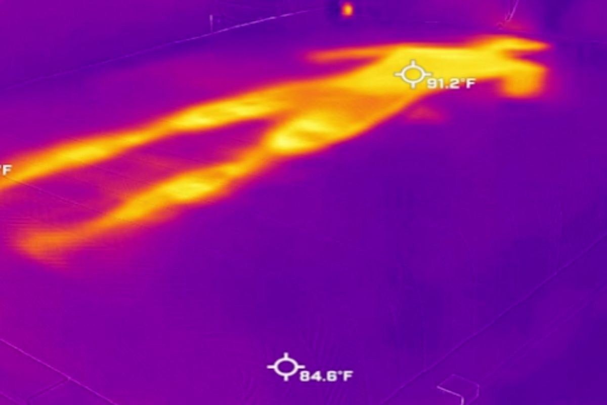 A heat image of a bed with a very visible outline of a person.