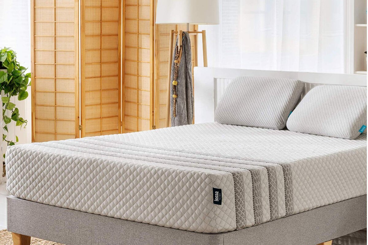 Leesa Legend Hybrid mattress close-up on gold frame with textured cover and throw blanket in bedroom setting