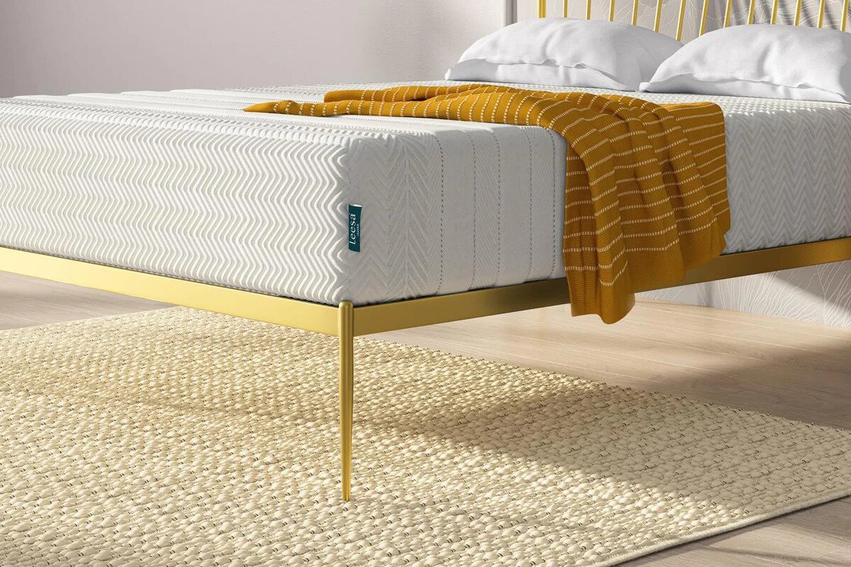 Leesa Legend Hybrid mattress close-up on gold frame with textured cover and throw blanket in bedroom setting