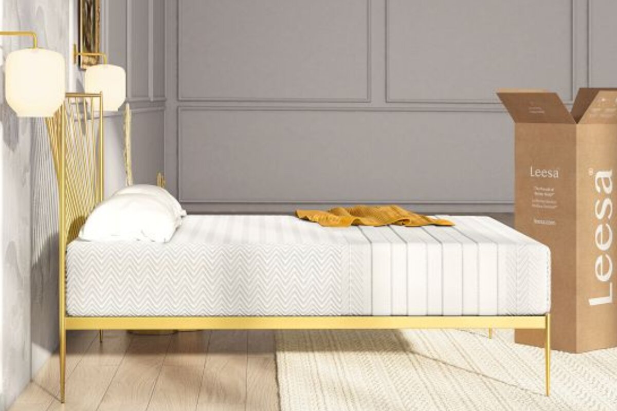 Leesa Legend Hybrid mattress on gold bed frame with textured cover and delivery box in modern bedroom
