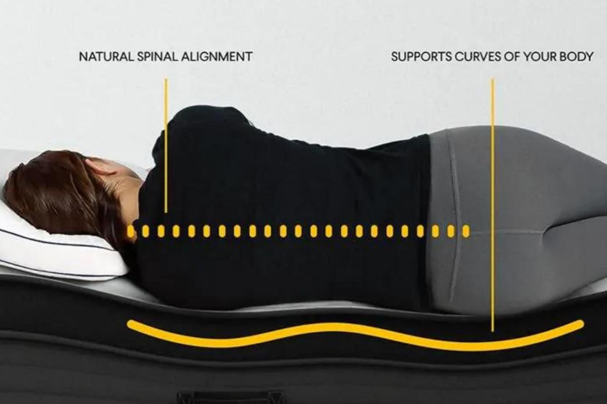 Side sleeper on Nolah Evolution 15 mattress demonstrating proper spinal alignment and ergonomic support