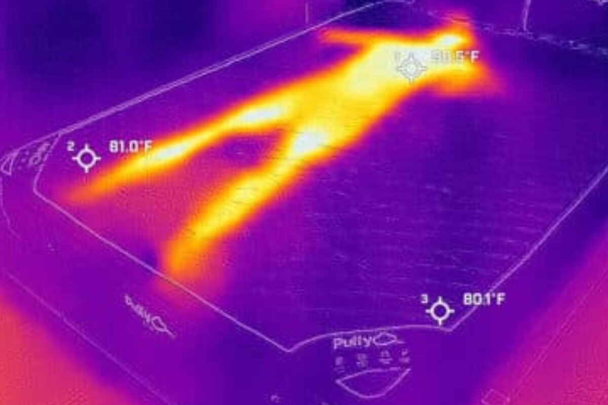 A heat image of a bed with a visible outline of a person.