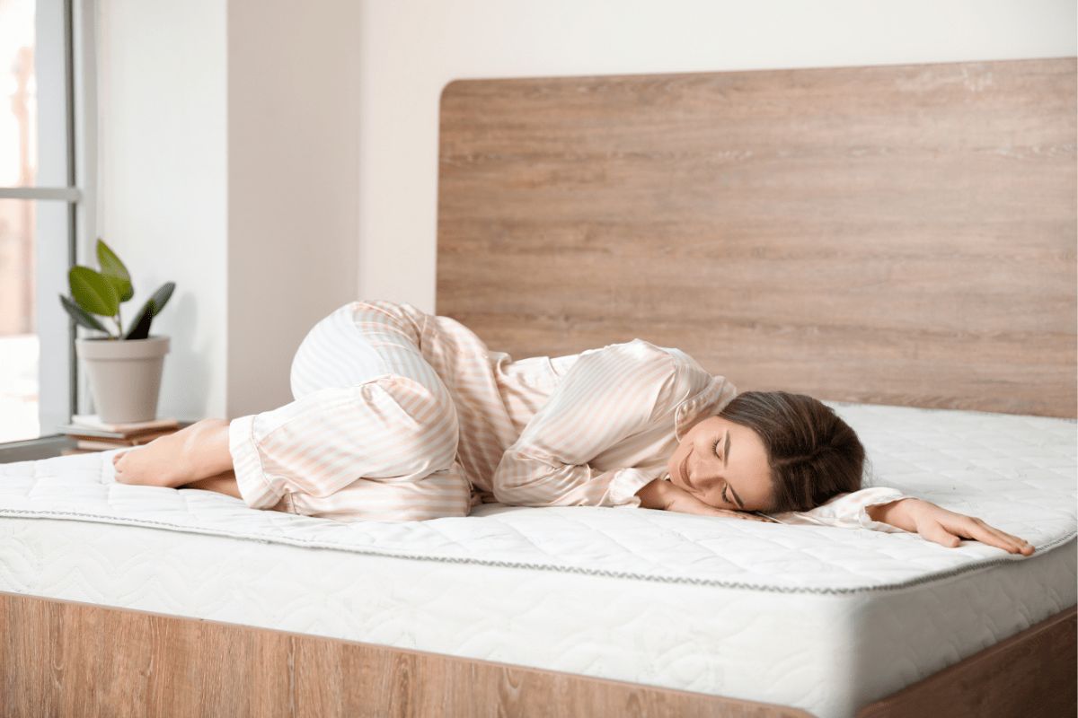 What Is a King Size Bed? Person sleeping comfortably on a king size bed demonstrating space and comfort for individuals