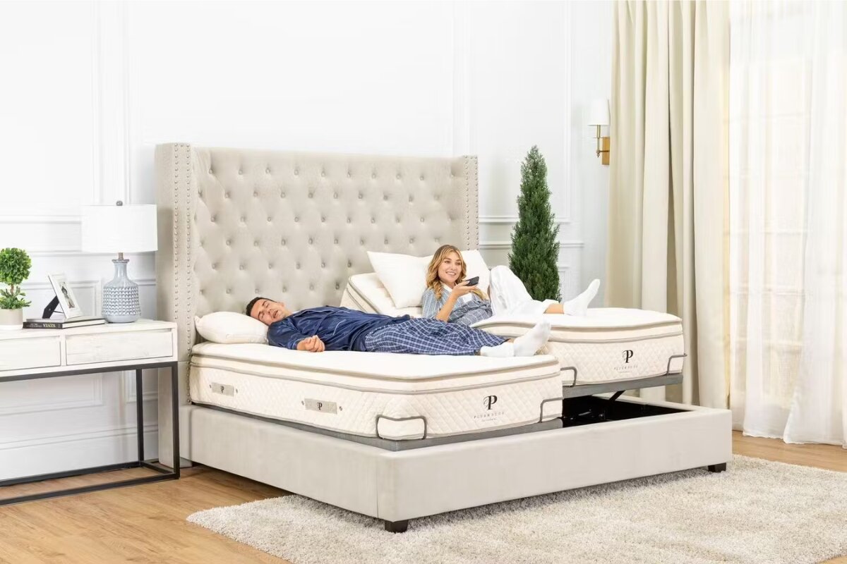 couple relaxing on a split king adjustable bed with separate head positions in a modern bedroom