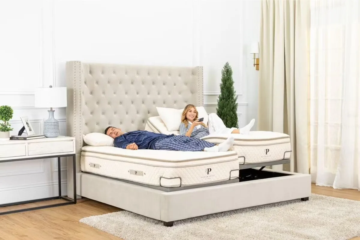 couple relaxing on a split king adjustable bed with separate head positions in a modern bedroom