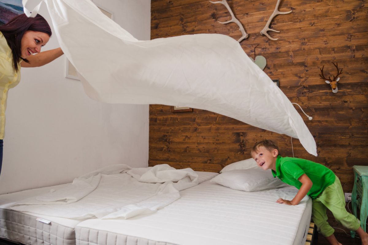 Split California king mattress setup showing two separate sides while making the bed