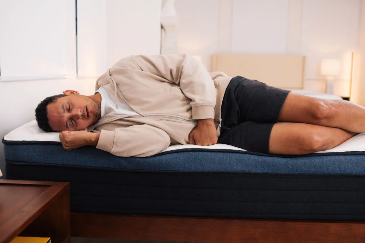 A man sleeping on a Helix Midnight Luxe mattress.