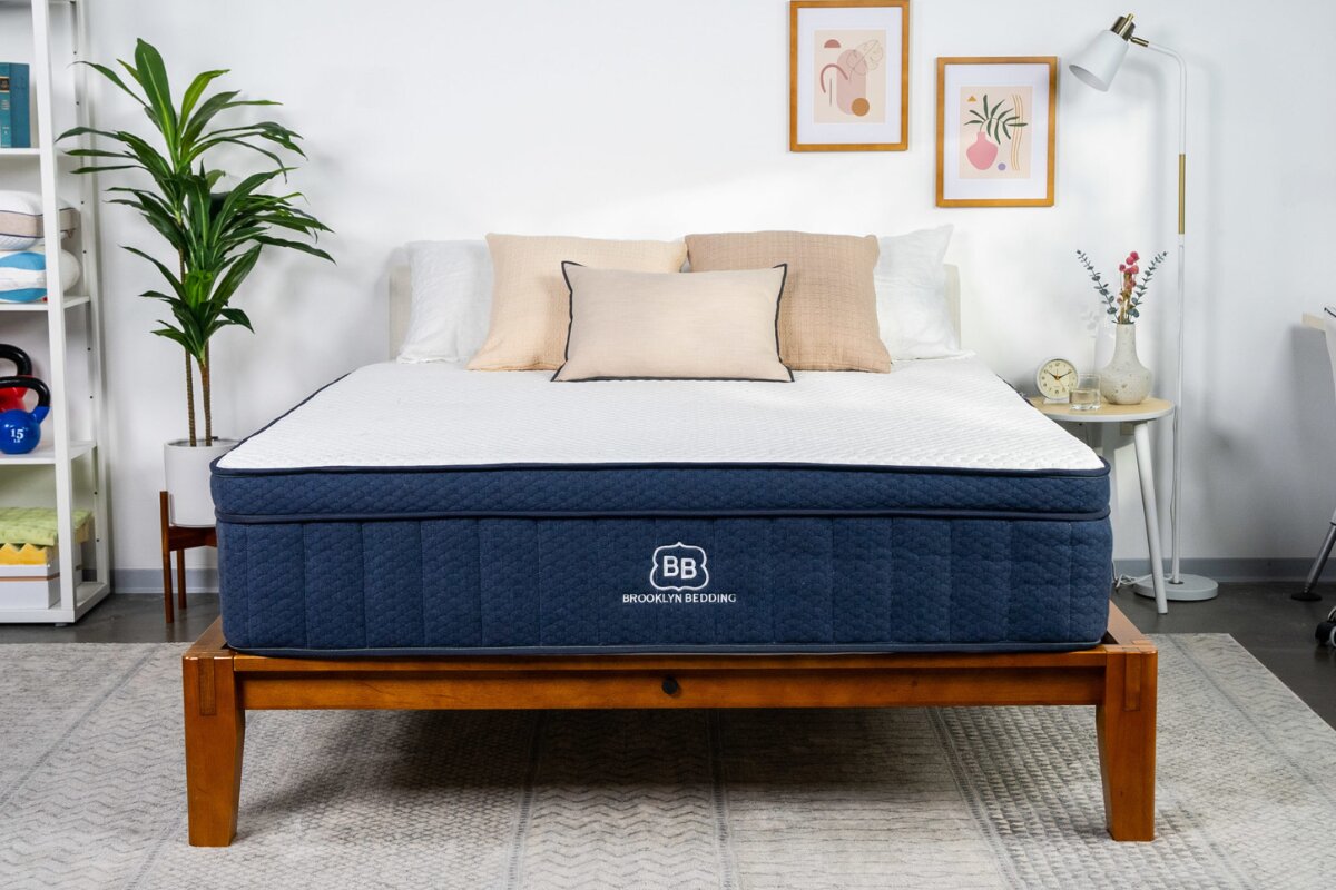 Brooklyn Bedding Aurora Luxe Cooling mattress on wooden bed frame in modern bedroom setup