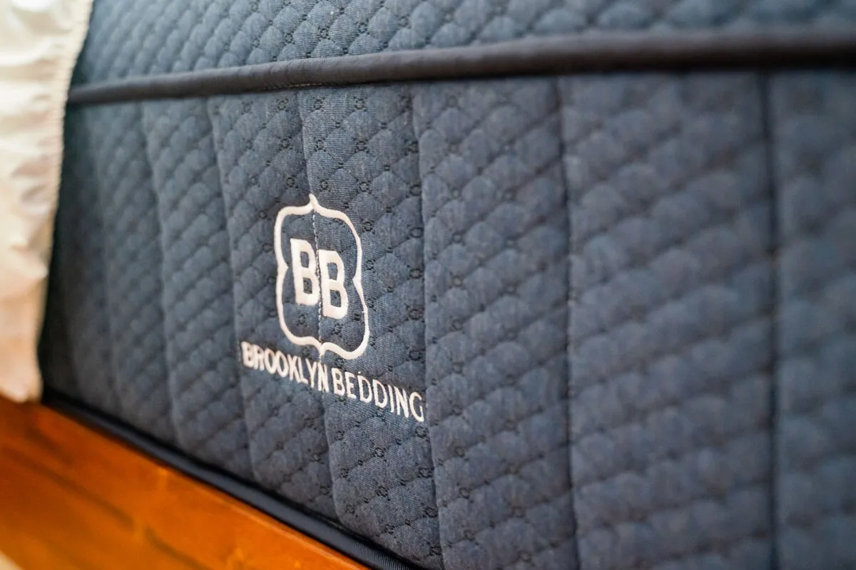 close up of brooklyn bedding aurora luxe cooling mattress side panel and stitched logo