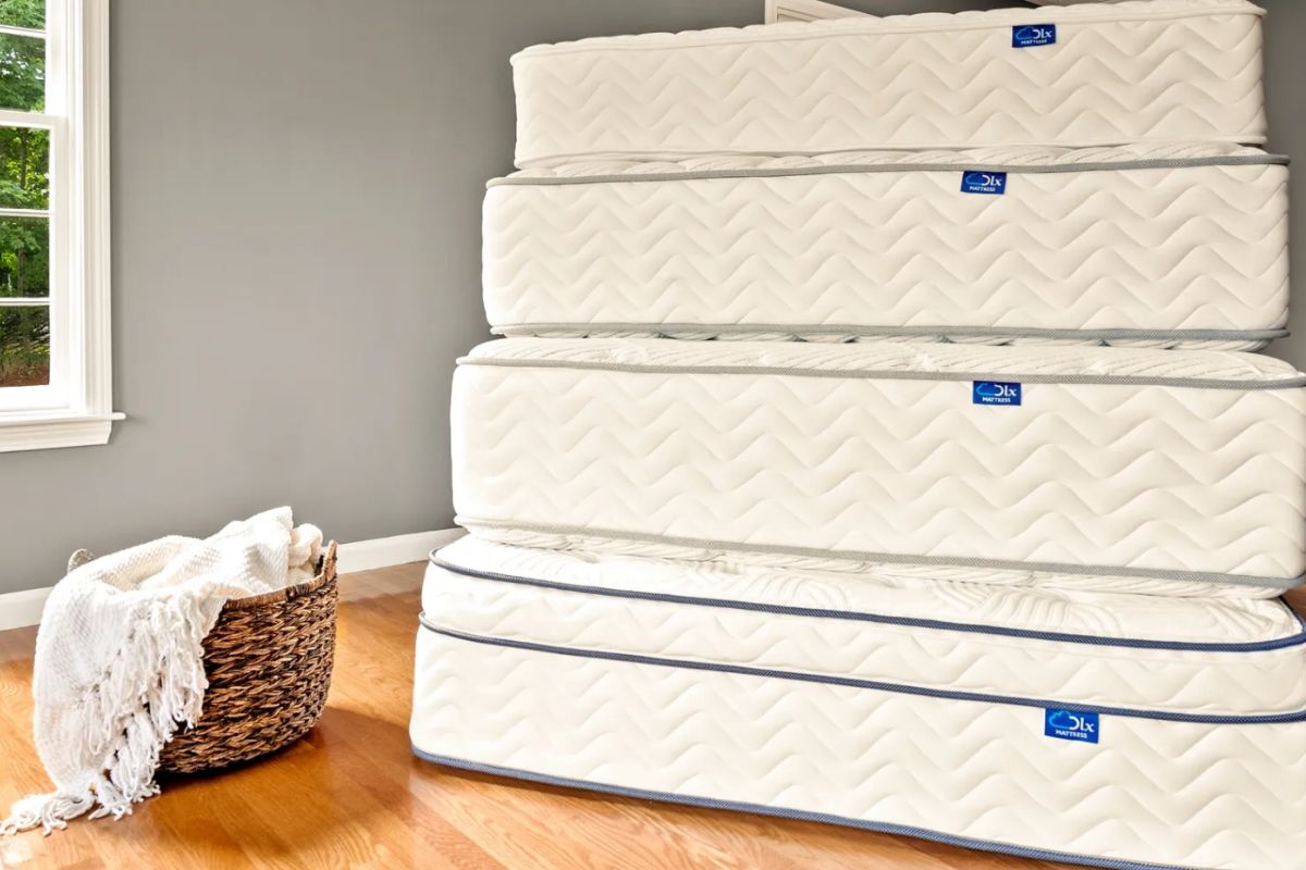 Stacked DLX Premier Hybrid mattresses demonstrating proper storage and handling to prevent damage and voided warranty