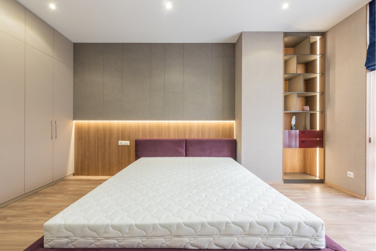 How Big is a California King Bed spacious modern bedroom with a california king mattress, built in shelving, and warm ambient lighting