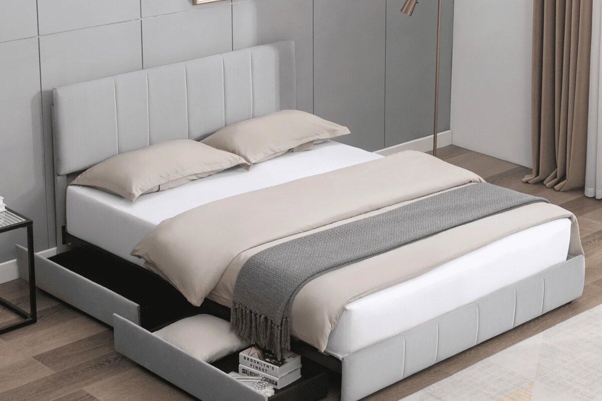 modern upholstered platform bed with built in storage drawers and neutral bedding in a minimalist bedroom