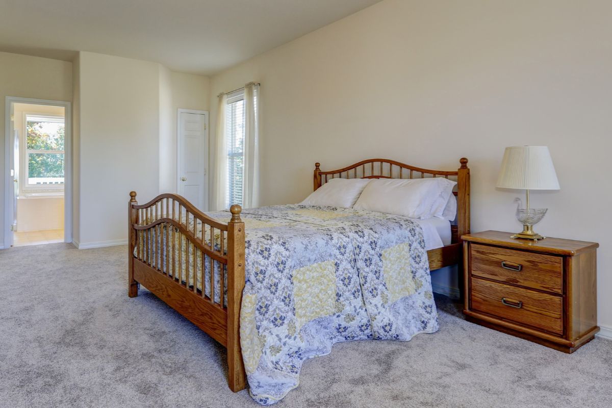 How Big Is a Queen Size Bed? Queen size bed in a spacious room demonstrating overall footprint and room layout compatibility