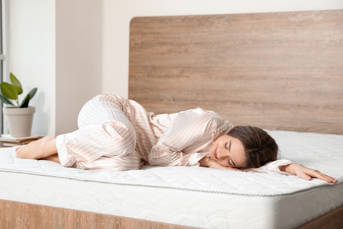 Person lying on a mattress demonstrating how mattress depth supports the body