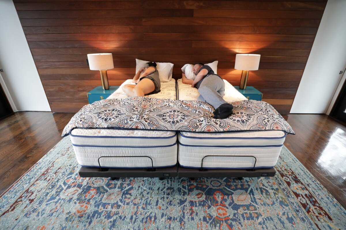 couple sleeping on split king mattress with separate adjustable bases in modern bedroom