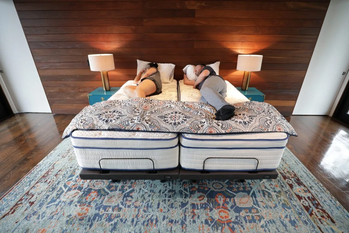 couple sleeping on split king mattress with separate adjustable bases in modern bedroom