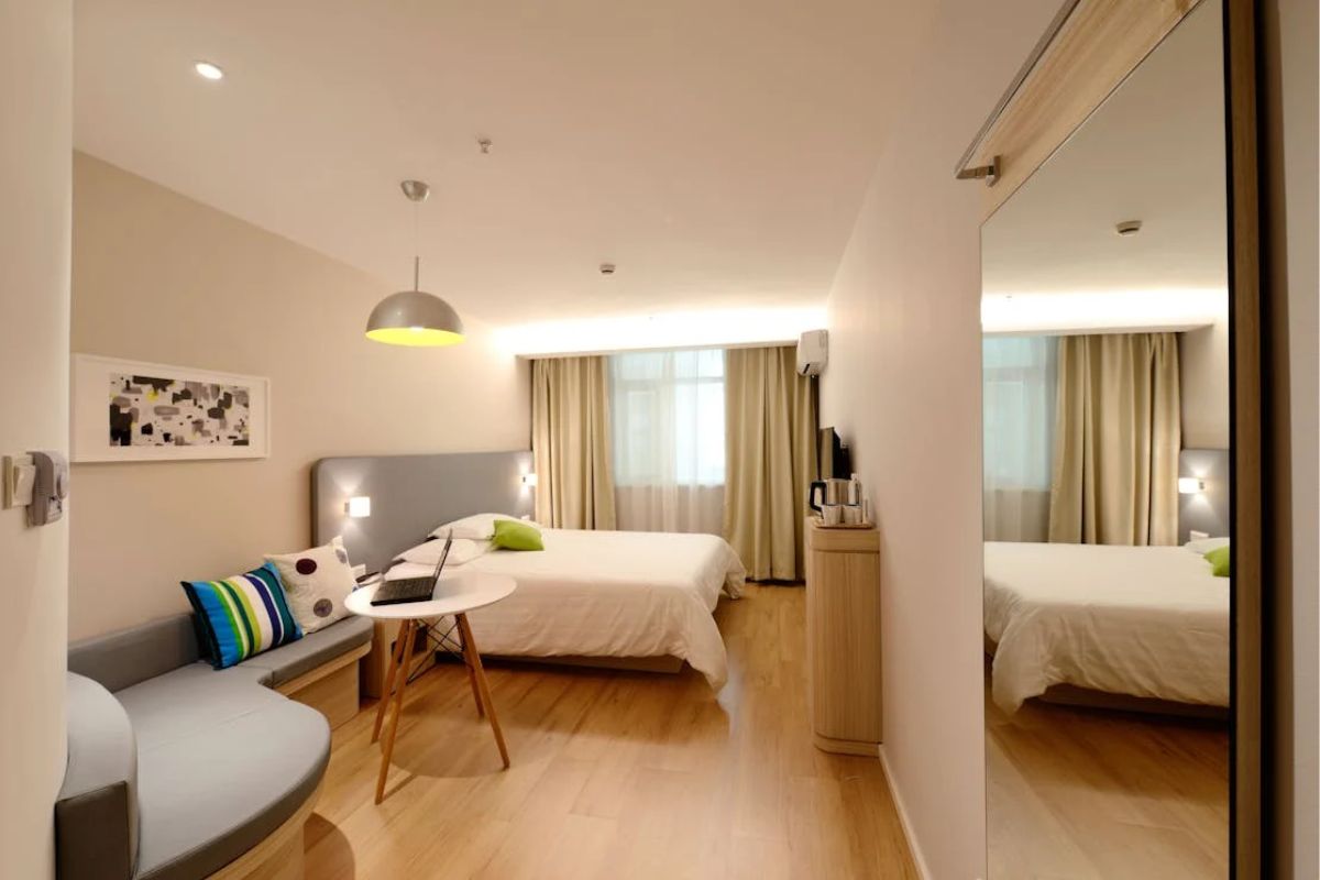 How Long is a California King Bed? Spacious modern bedroom setup demonstrating how a California king bed fits in larger rooms