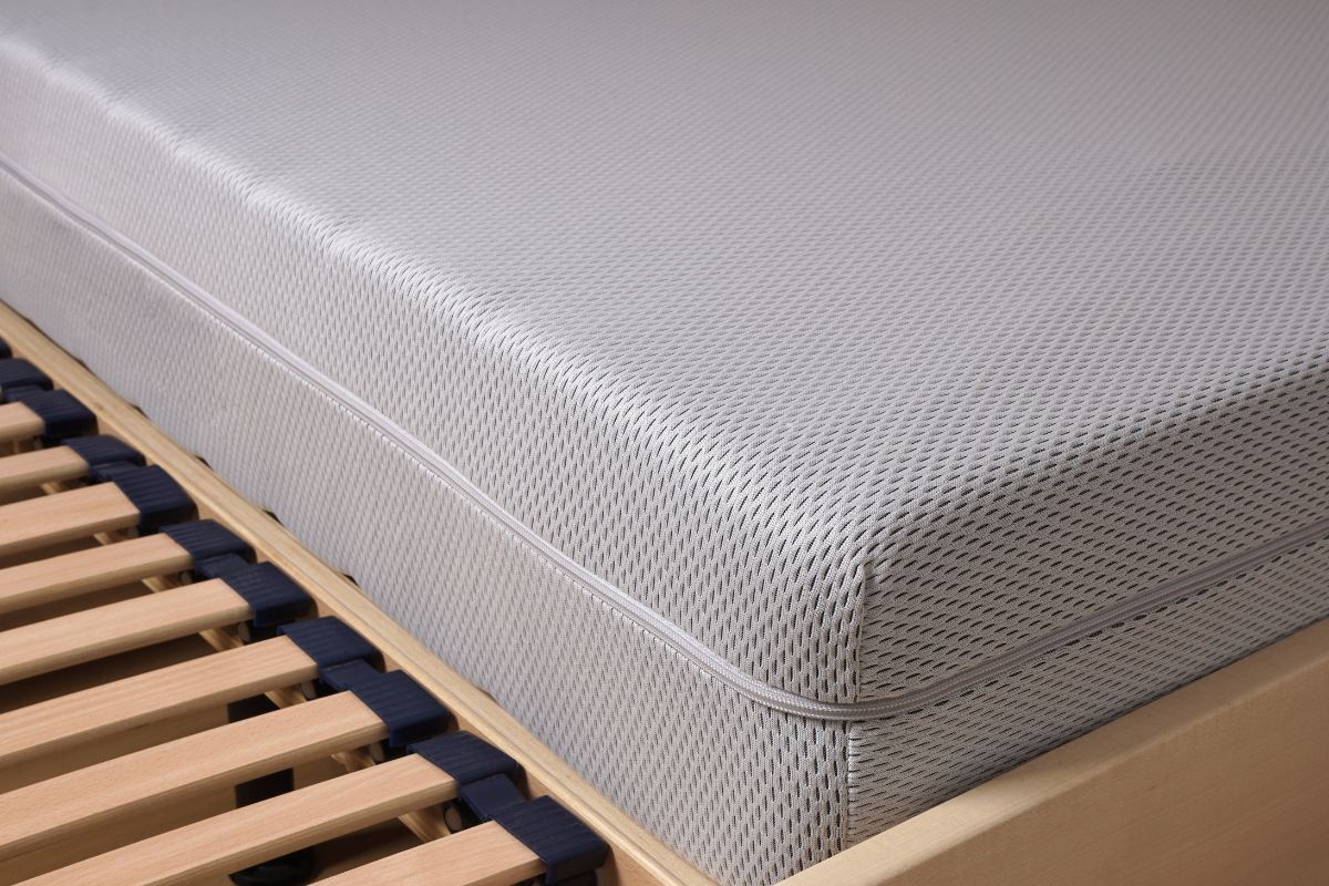 Close-up of a mattress on a bed frame highlighting thickness and edge profile