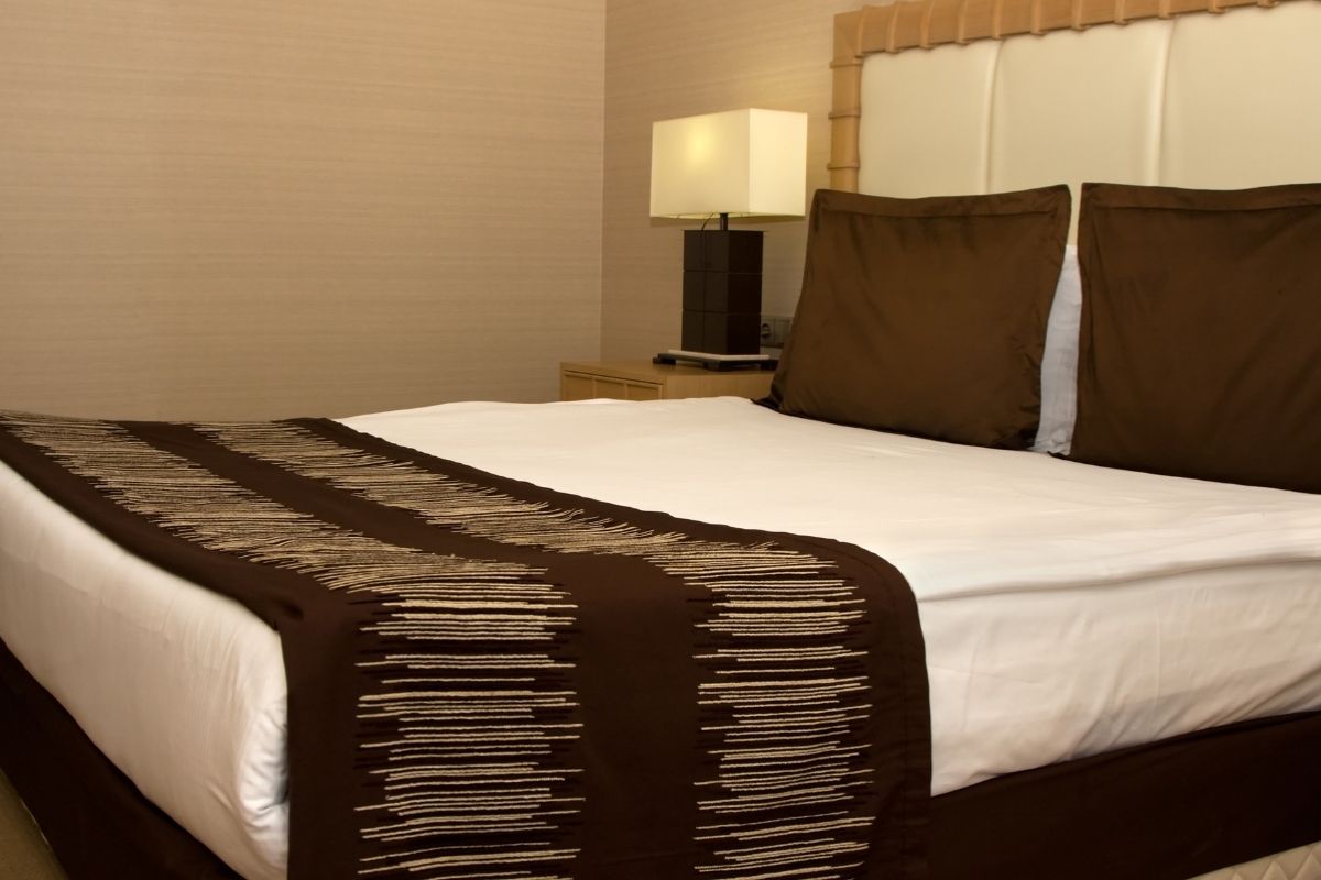 Queen size bed setup showing mattress height and overall thickness in a bedroom