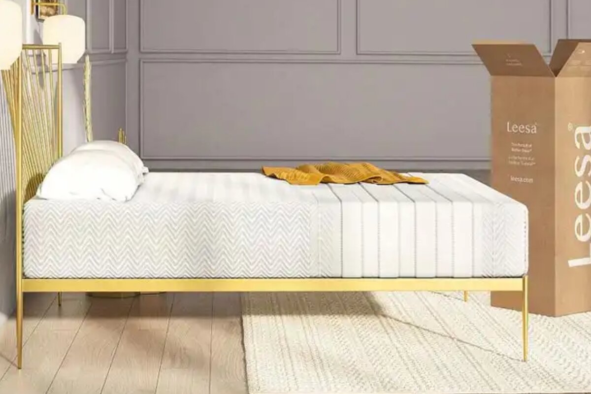 Leesa Legend Hybrid mattress on gold bed frame with textured cover and delivery box in modern bedroom