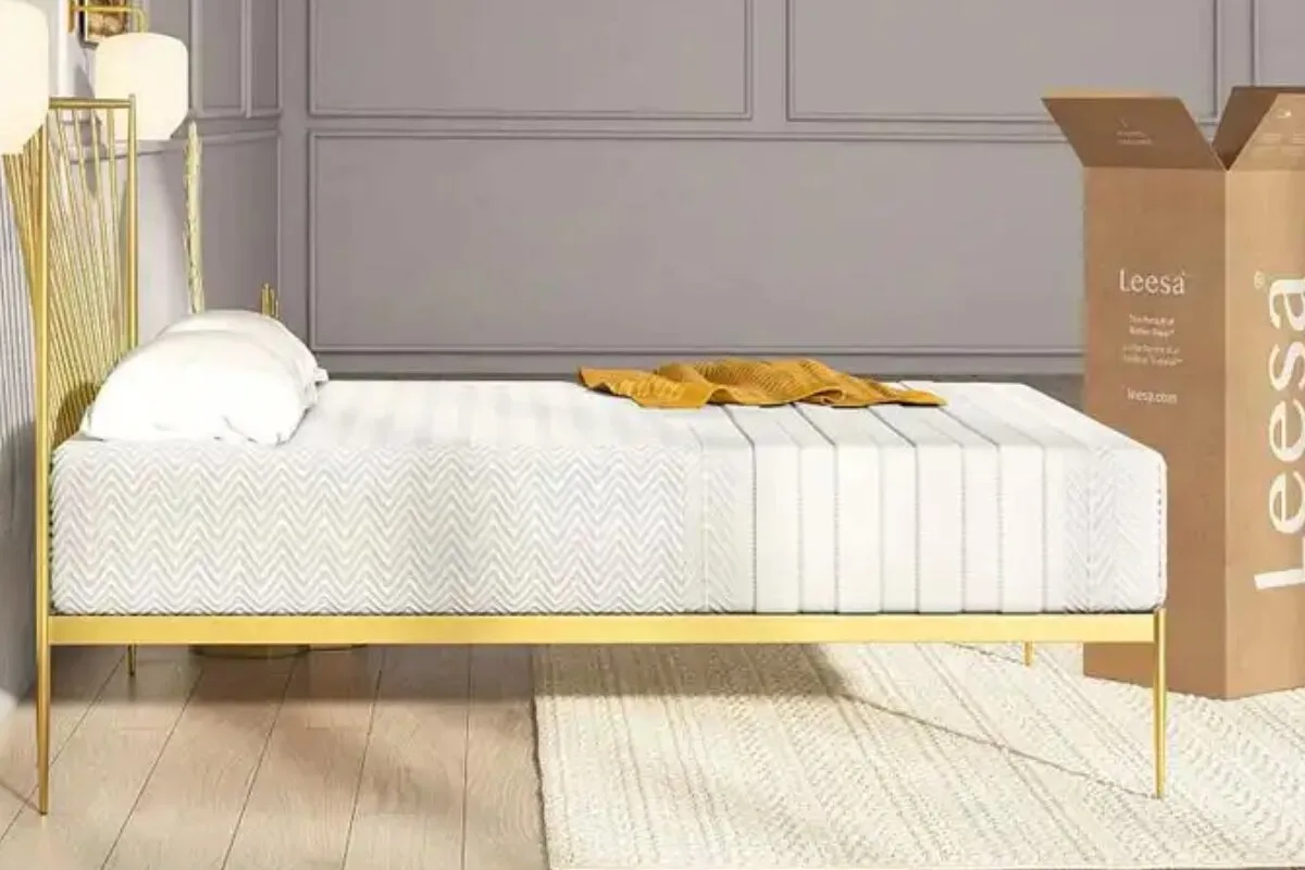 Leesa Legend Hybrid mattress on gold bed frame with textured cover and delivery box in modern bedroom