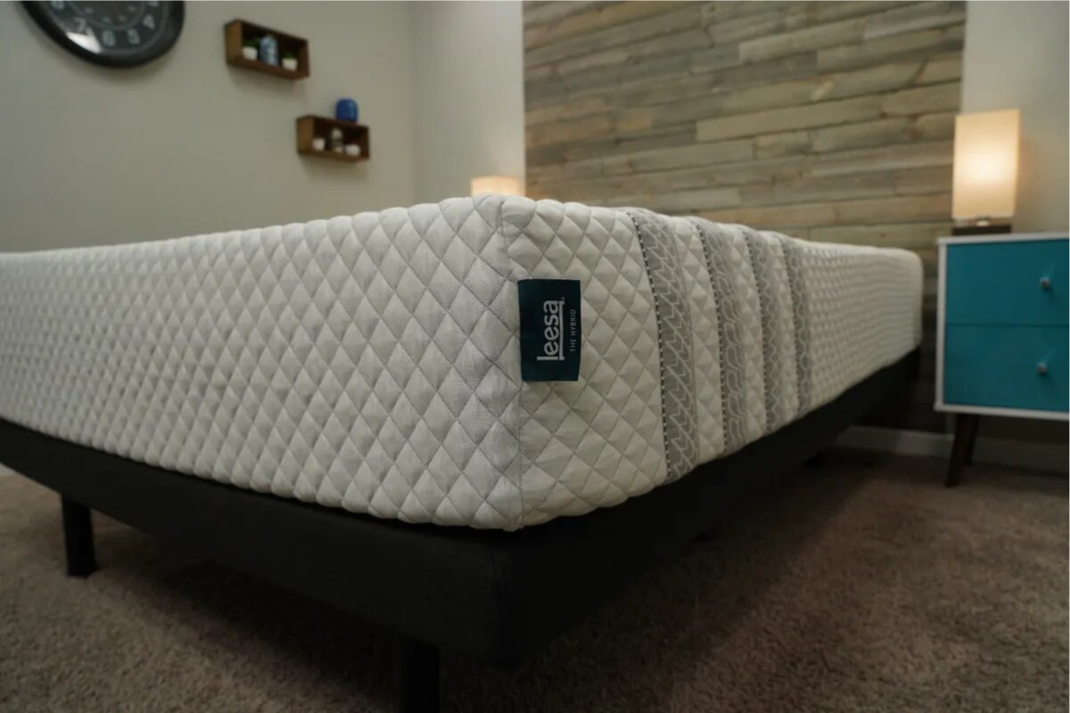 What to Expect When Returning a Leesa Sapira Hybrid close-up of leesa sapira hybrid mattress corner on black bed frame in modern bedroom