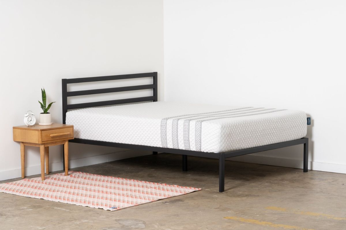 The Leesa Sapira Hybrid mattress in the corner of a bedroom.