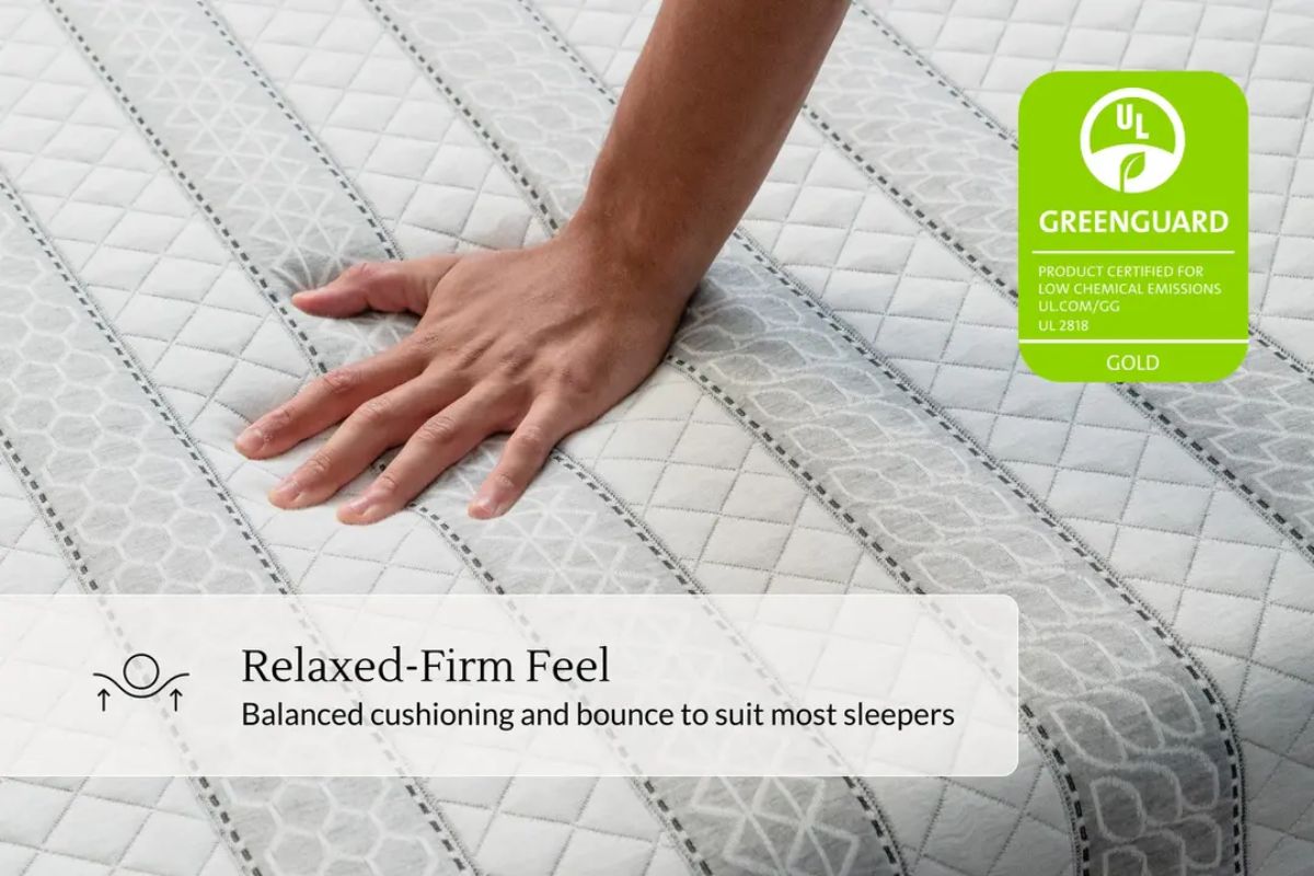 A person pressing on a bed with a greenguar gold certification and a relaxed-firm feel(balanced cushioning and bounce to suit most sleepers) tag.