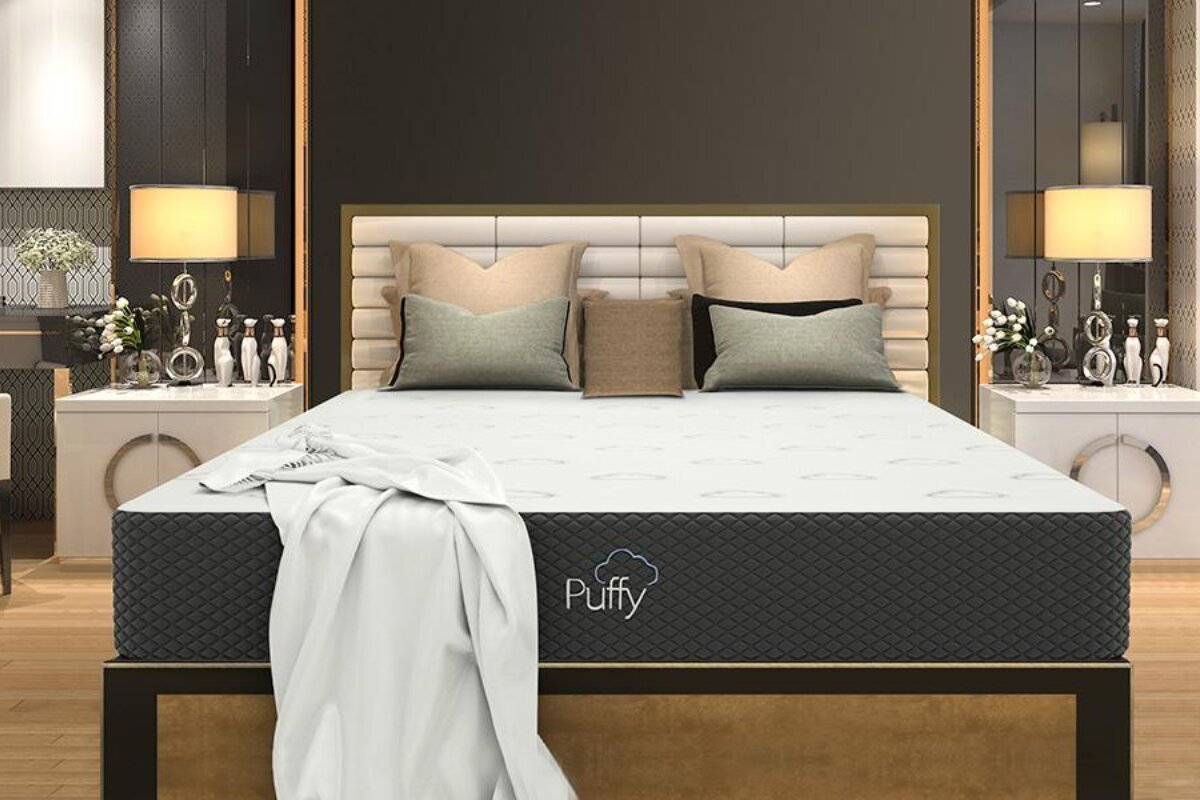 The Puffy Cloud mattress with pillows and a blanket.