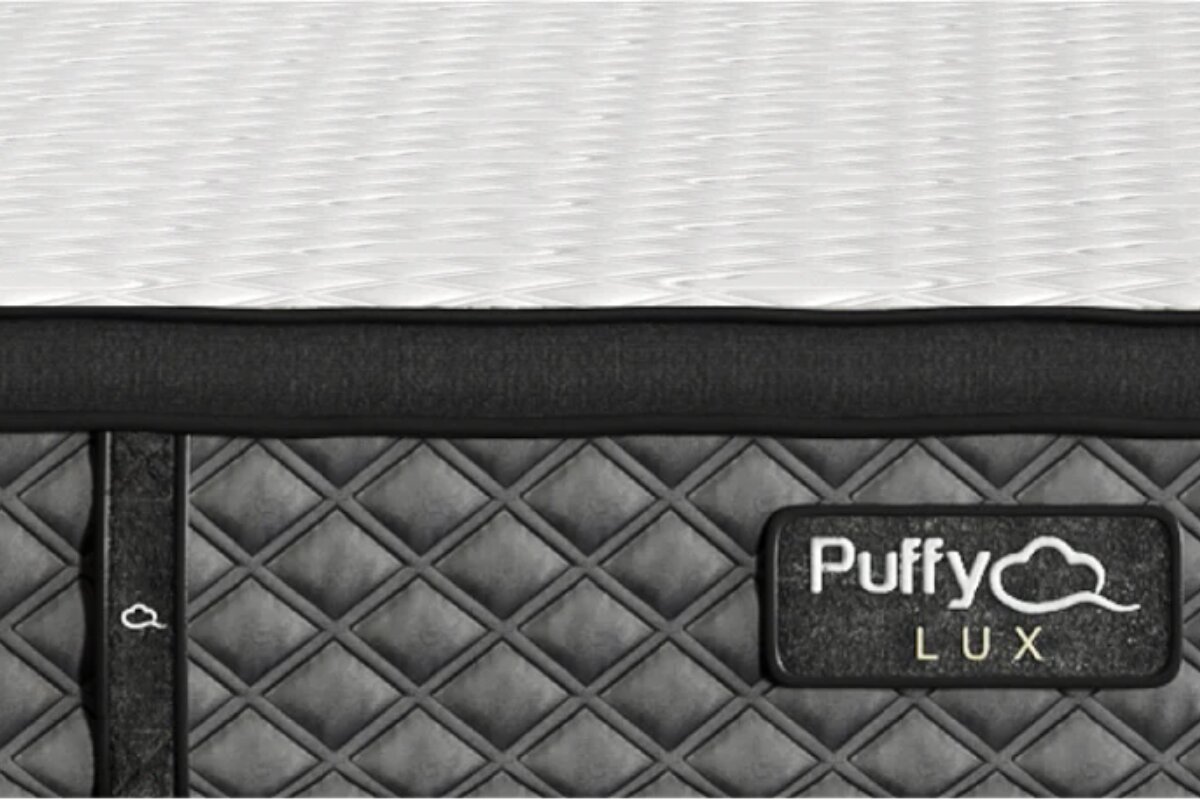 Close-up of Puffy Lux Mattress side panel with stitched diamond pattern and brand logo label