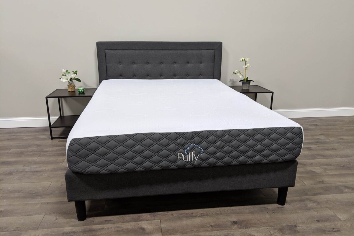 Puffy Lux mattress on platform bed with gray upholstered headboard in modern bedroom
