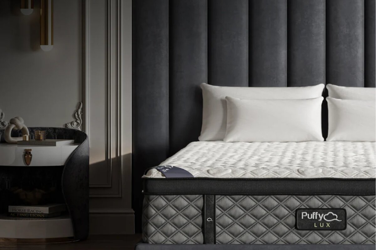 How to Avoid Voiding a Puffy Lux Mattress’ Warranty Puffy Lux mattress with quilted cooling top and branded side panel on upholstered bed frame*