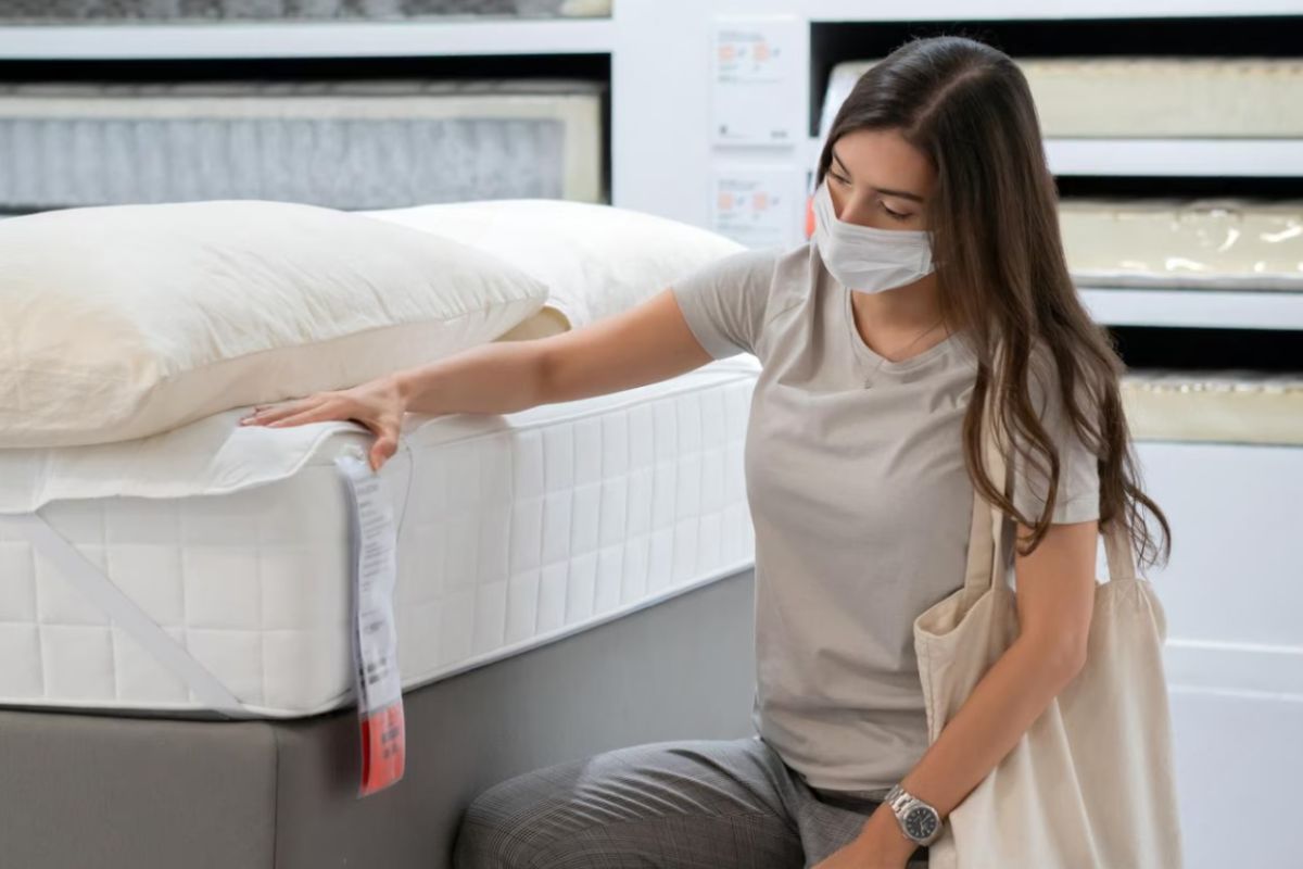 What Are the Dimensions of a Queen Size Bed? Shopper checking a mattress in-store highlighting real-life scale of a queen size bed