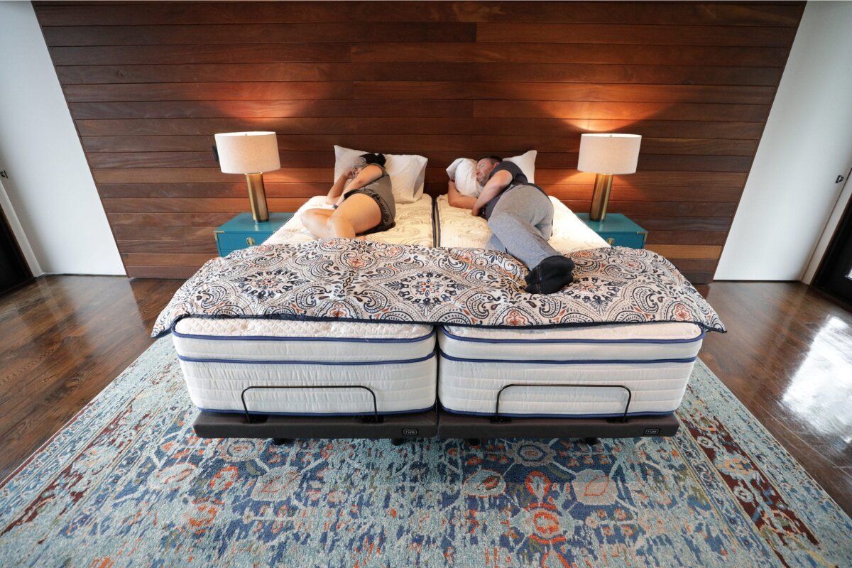 couple sleeping on a split california king mattress with two independent sides