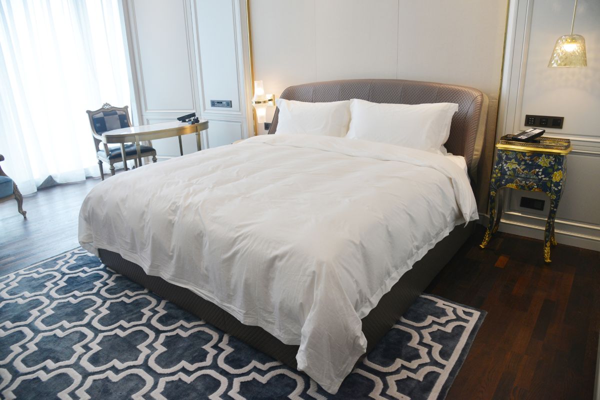 California King bed in bedroom setup illustrating longer mattress size and layout