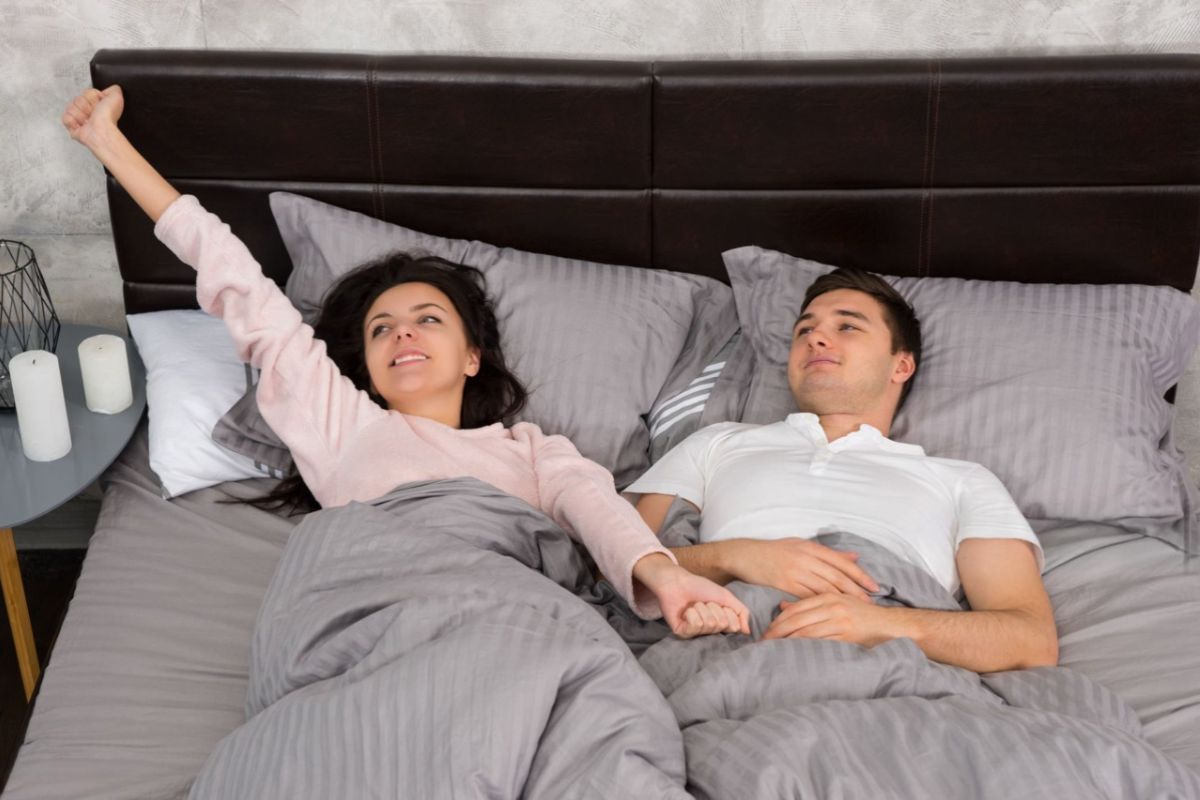 What Size Is a Queen Mattress? Couple lying comfortably on a queen mattress demonstrating space for two adults