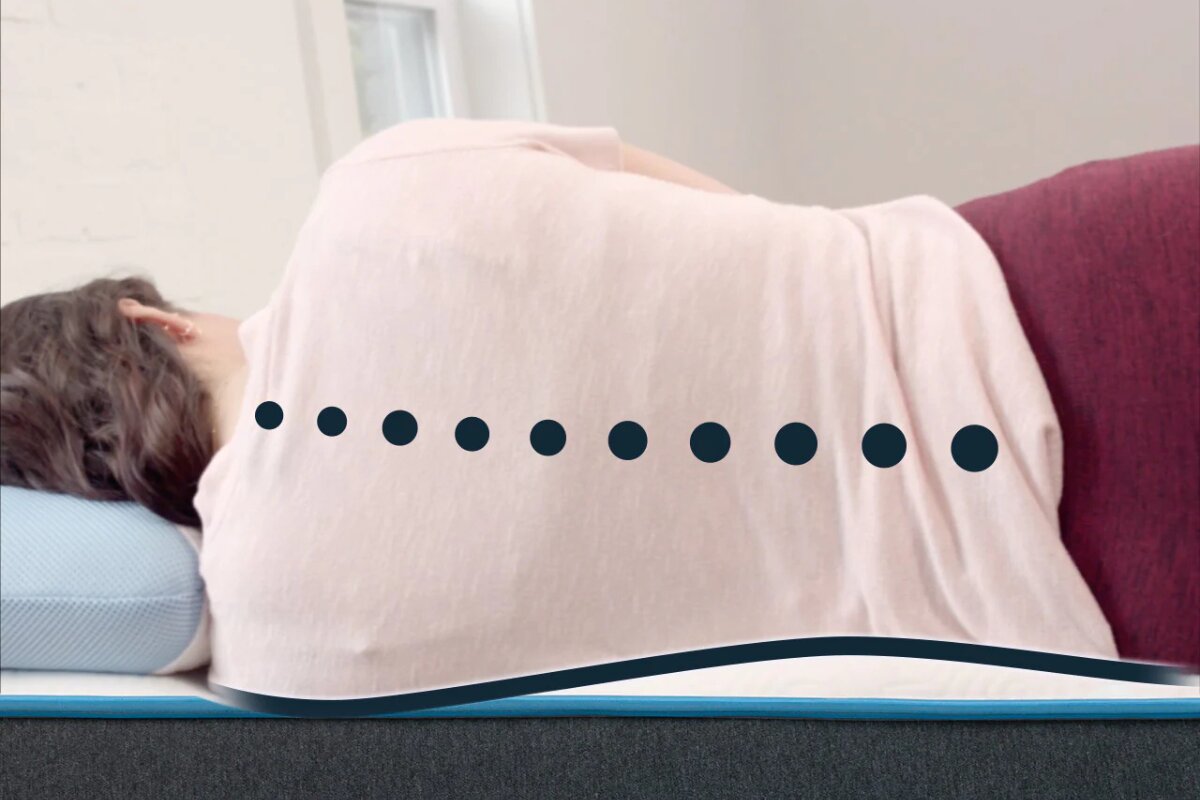 side sleeper lying on bear original mattress showing spinal alignment and pressure relief
