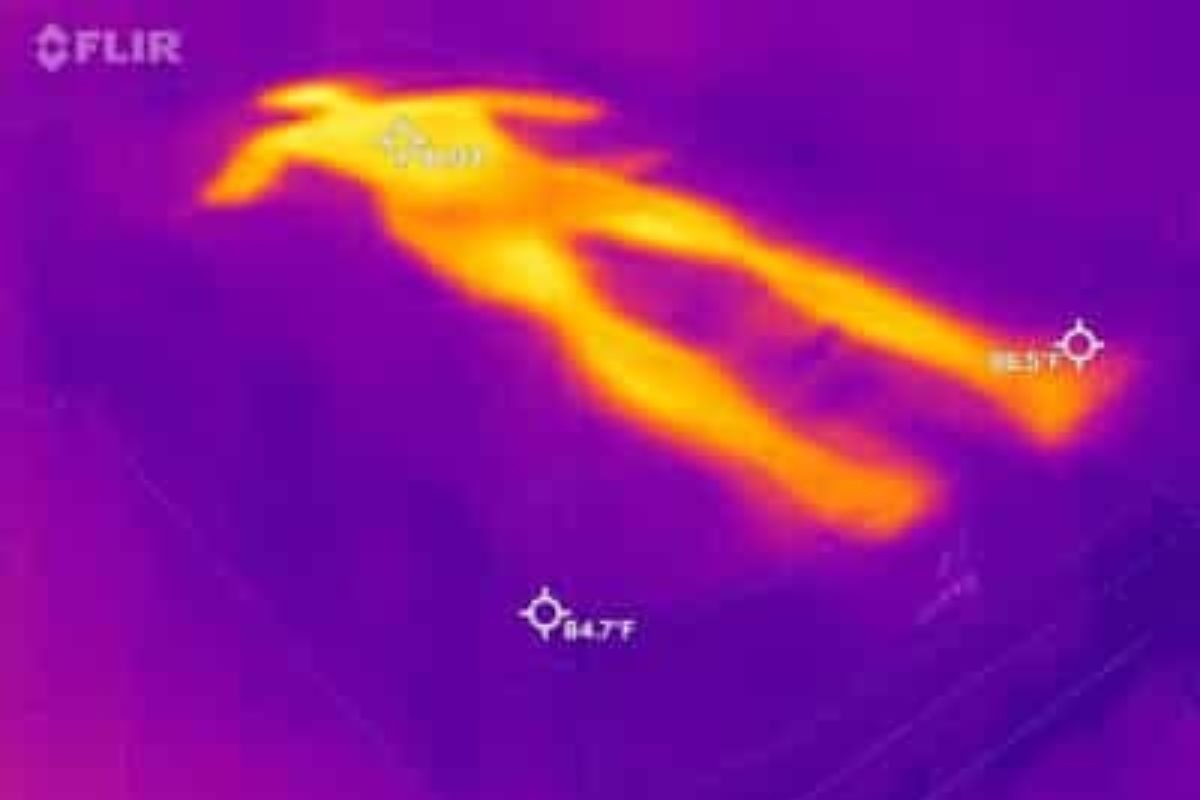 A heat image of a bed where a person laid down on it, very visible.