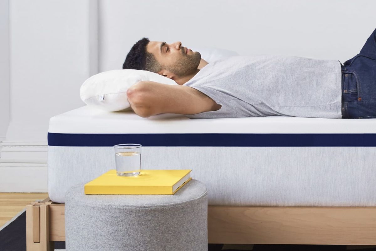 User relaxing on Helix Midnight mattress while testing comfort during trial period