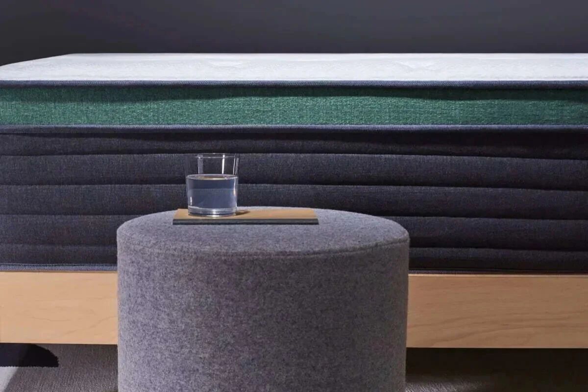 A close up of Helix Twilight Luxe with a glass of water next to it.