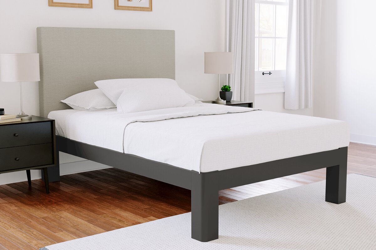 How Big is a Full XL Mattress? full xl bed frame with tall upholstered headboard in bright modern bedroom with neutral decor and white bedding