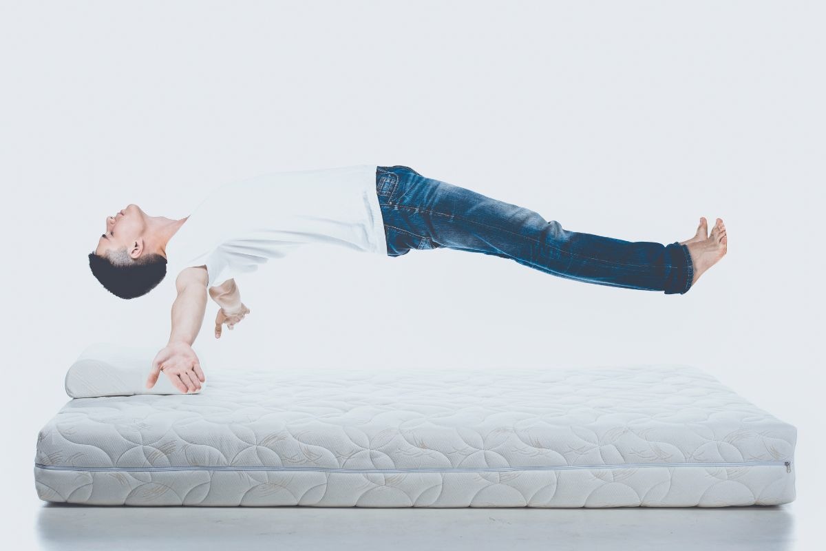 How Deep is a Standard Twin Mattress? Person lying on a mattress demonstrating how mattress depth supports body weight and comfort